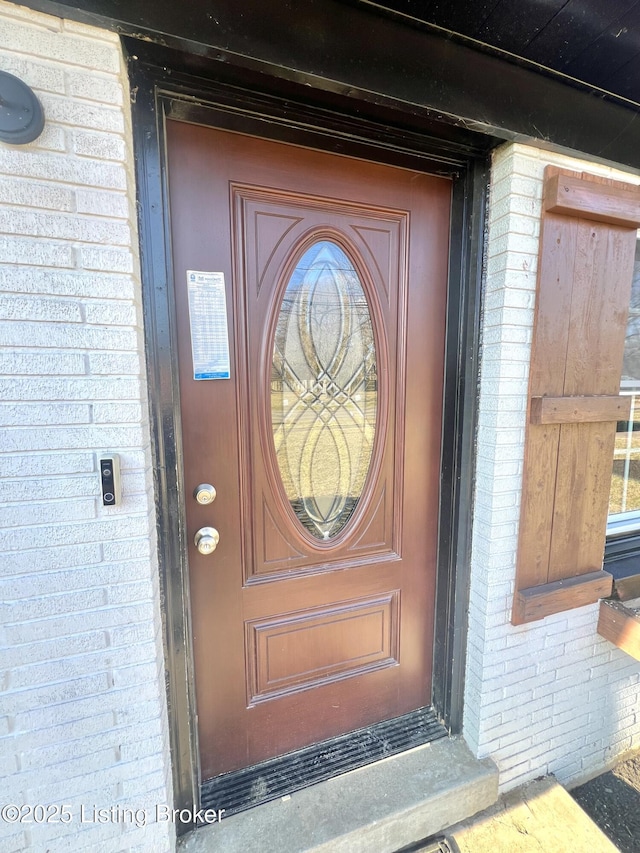 entrance to property with brick siding