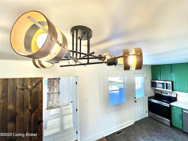 kitchen featuring parquet floors, appliances with stainless steel finishes, visible vents, and green cabinetry