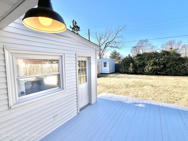 wooden deck with an outdoor structure and a storage unit