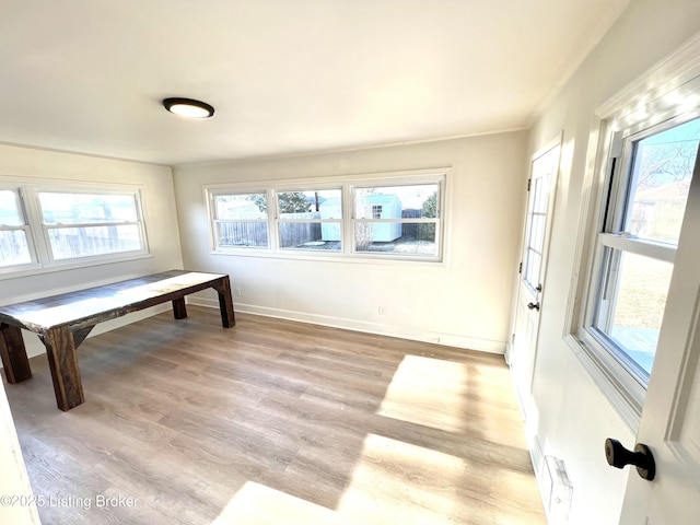 home office with light wood-type flooring and baseboards