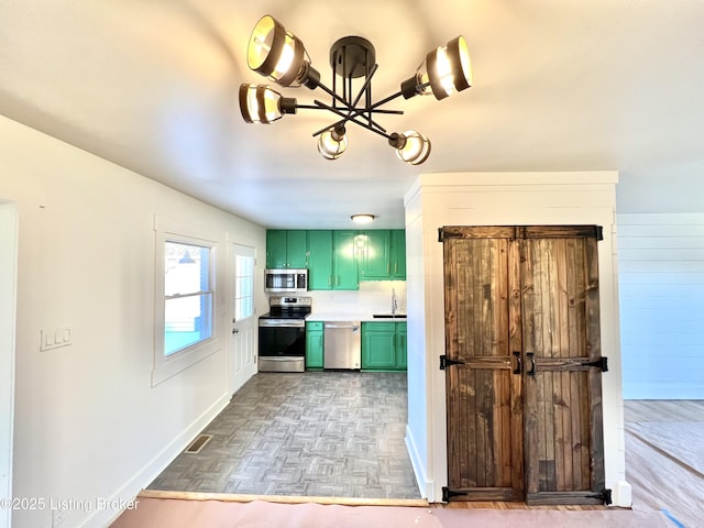 kitchen featuring visible vents, baseboards, appliances with stainless steel finishes, light countertops, and green cabinets