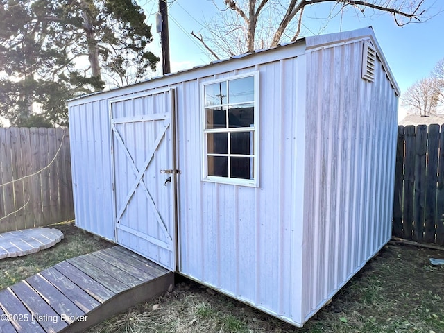 view of shed with a fenced backyard