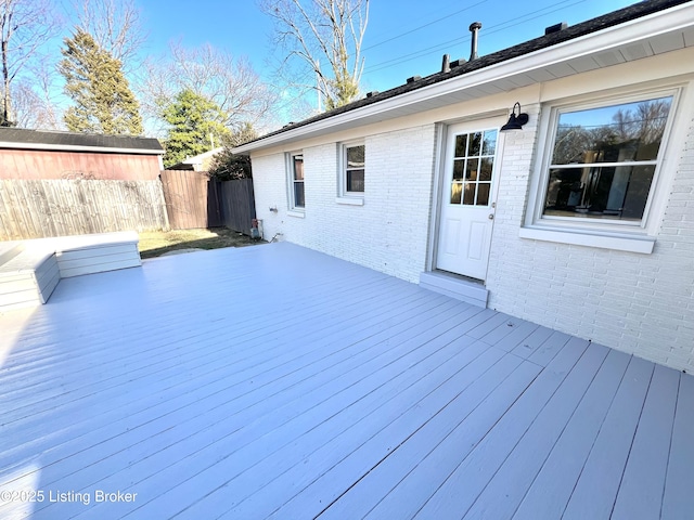 wooden terrace featuring fence