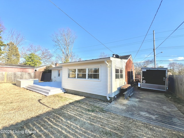 back of house with a yard and fence