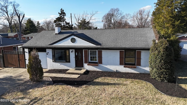 single story home with concrete driveway, a chimney, roof with shingles, a gate, and brick siding