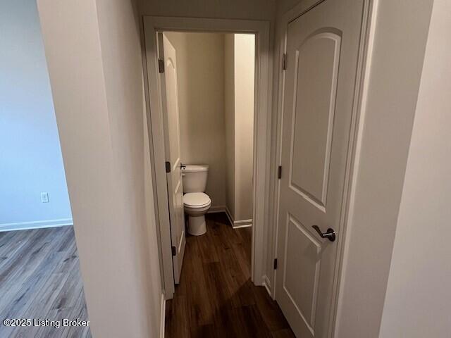 bathroom featuring wood finished floors, toilet, and baseboards