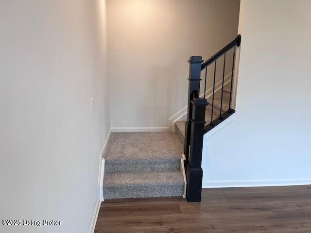 stairs with baseboards and wood finished floors