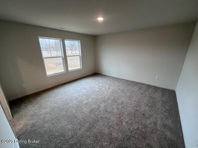 carpeted spare room with baseboards