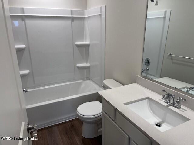 full bathroom with vanity, shower / bathing tub combination, wood finished floors, and toilet