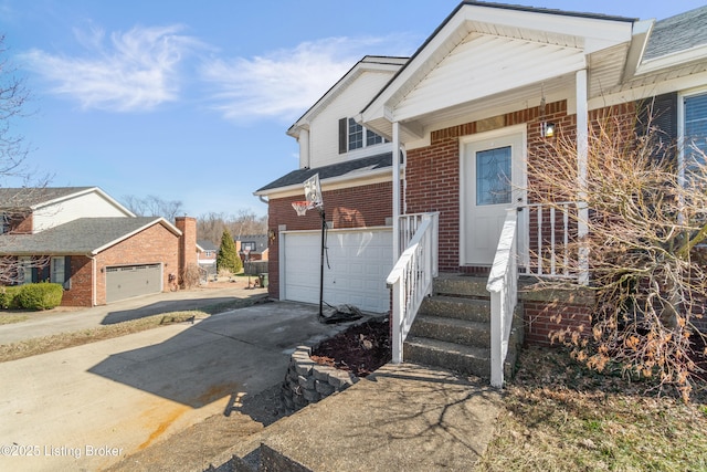 view of front of house featuring a porch, concrete driveway, brick siding, and a garage