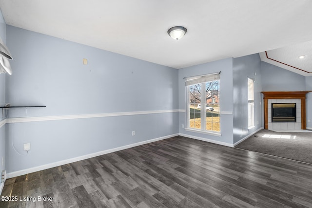 unfurnished living room featuring a fireplace, wood finished floors, and baseboards