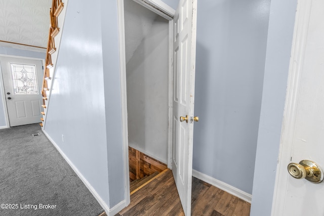 foyer featuring baseboards and wood finished floors