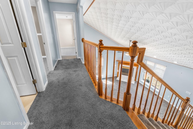 hall featuring carpet floors and baseboards