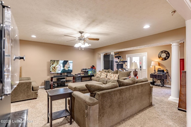 living room featuring decorative columns, recessed lighting, light carpet, ceiling fan, and a textured ceiling