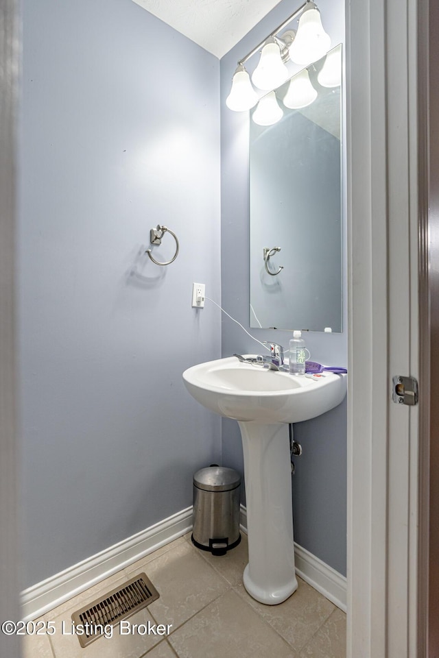 bathroom with tile patterned flooring, visible vents, and baseboards