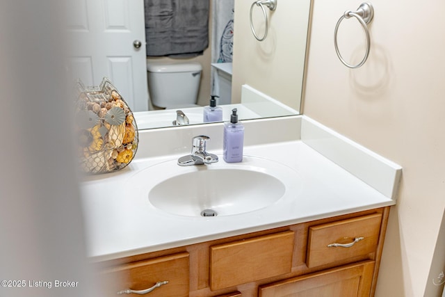 bathroom with toilet and vanity