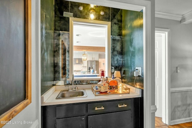 bar with crown molding and a sink