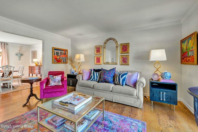 living room with baseboards, wood finished floors, and crown molding