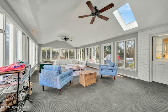 sunroom / solarium with lofted ceiling with skylight, plenty of natural light, and a ceiling fan