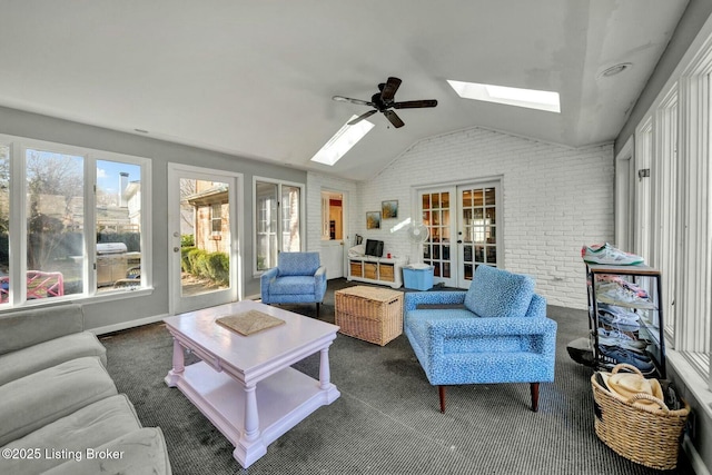 sunroom featuring vaulted ceiling with skylight, french doors, and ceiling fan