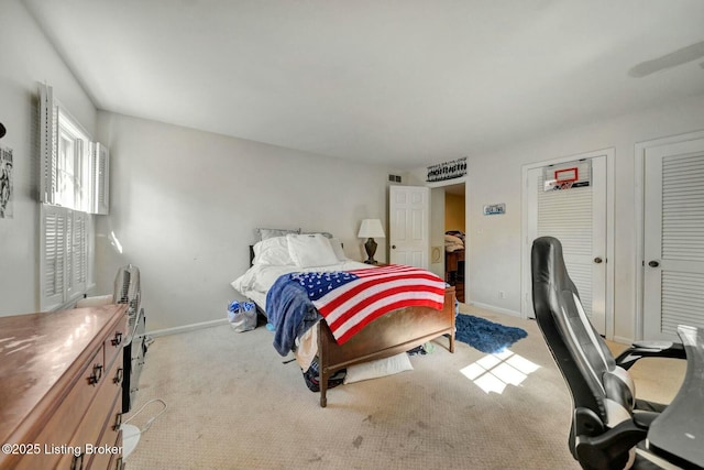 bedroom with visible vents, baseboards, and carpet flooring