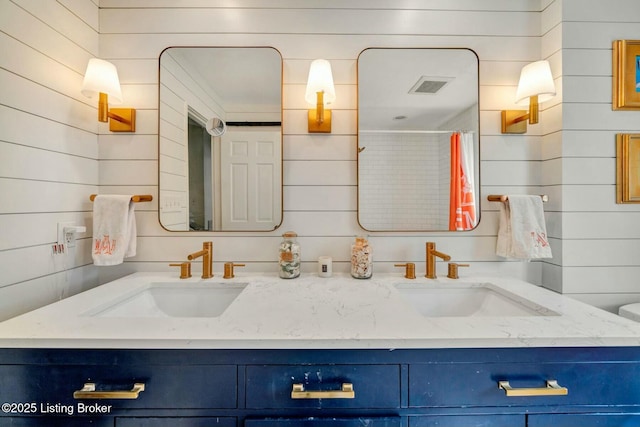 full bathroom featuring visible vents, a sink, and double vanity