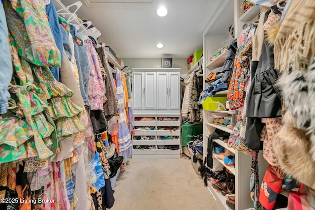 walk in closet with carpet