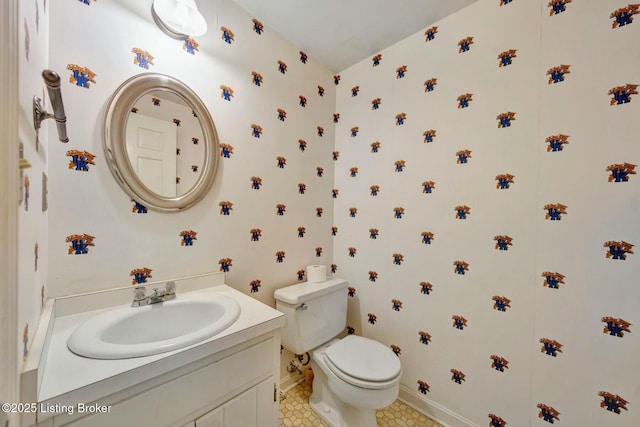 half bath with vanity, toilet, and baseboards