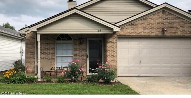 view of front of property featuring a garage, brick siding, driveway, and a chimney