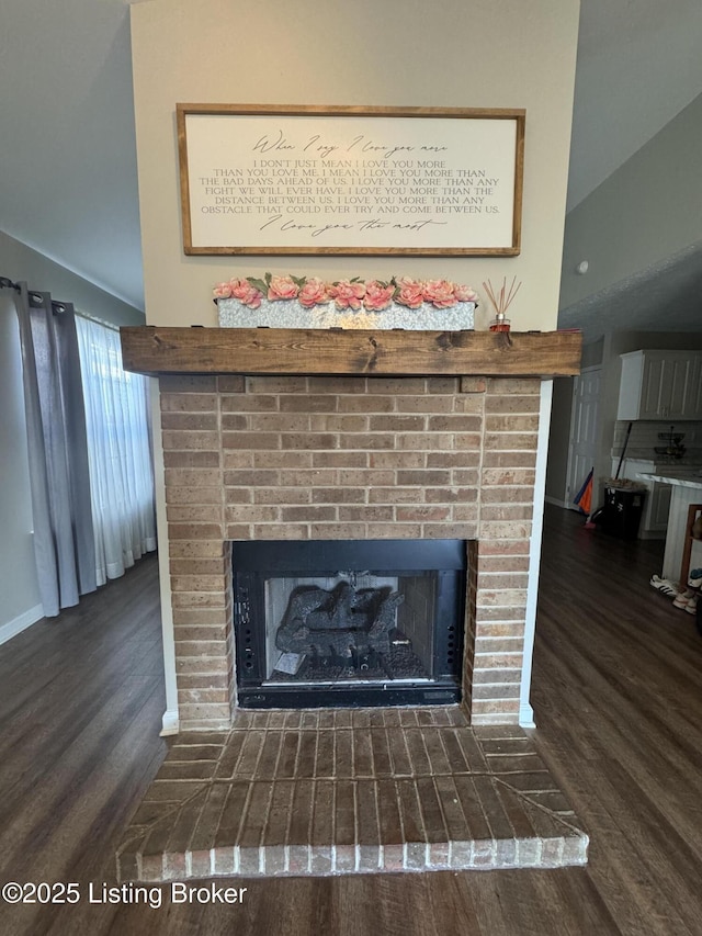 interior details with a brick fireplace and wood finished floors