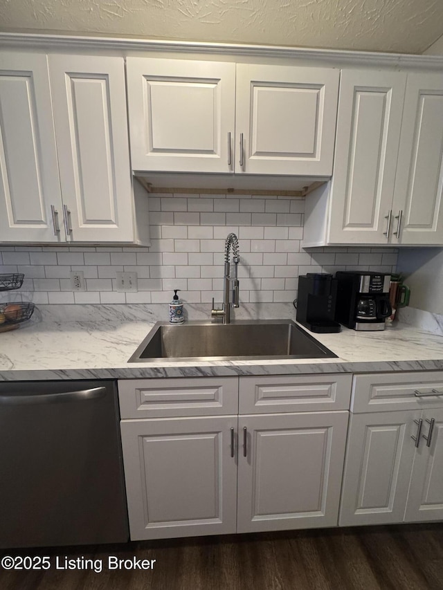 kitchen featuring a sink, tasteful backsplash, white cabinets, and dishwasher