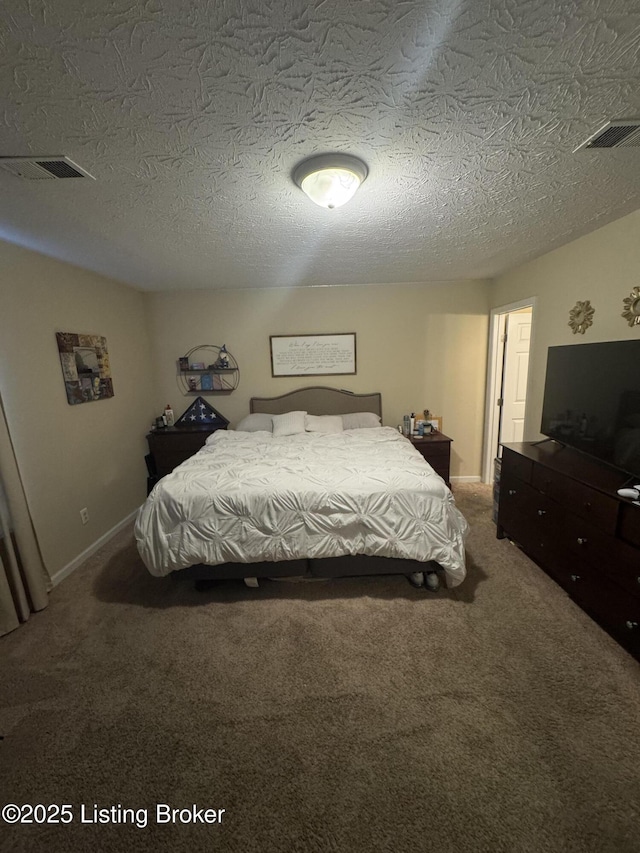 carpeted bedroom with visible vents, a textured ceiling, and baseboards