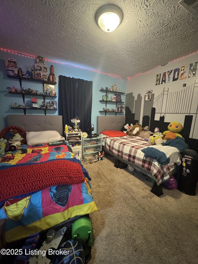 bedroom featuring a textured ceiling and carpet