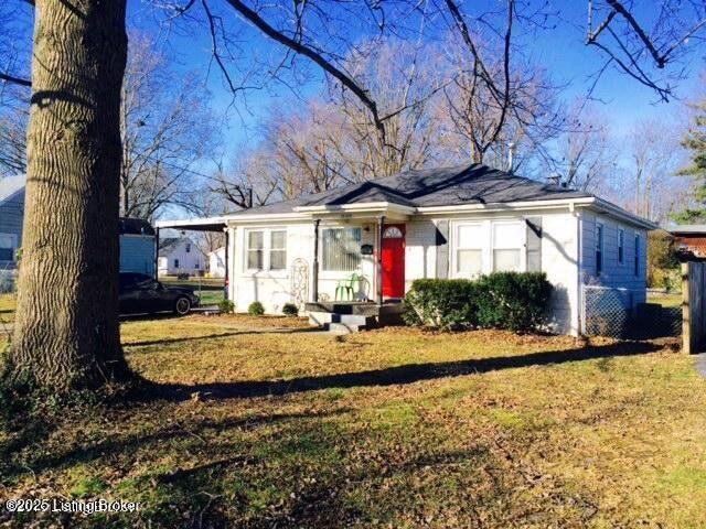 bungalow featuring a carport and a front yard