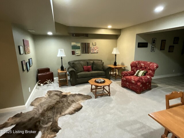 carpeted living area featuring recessed lighting and baseboards