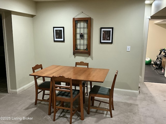 dining area with carpet floors and baseboards