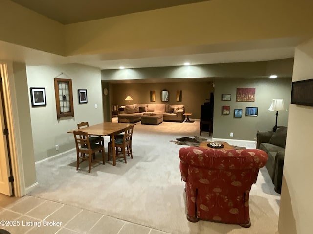 dining space featuring light carpet and baseboards