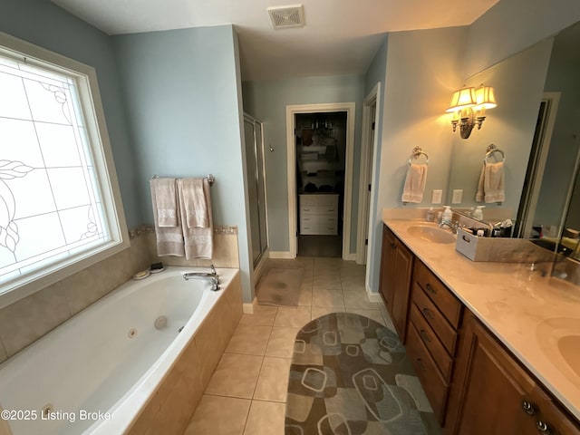 bathroom featuring double vanity, a stall shower, visible vents, a whirlpool tub, and tile patterned flooring