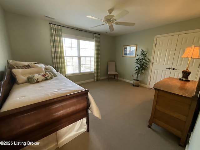 bedroom featuring carpet floors, a closet, visible vents, a ceiling fan, and baseboards