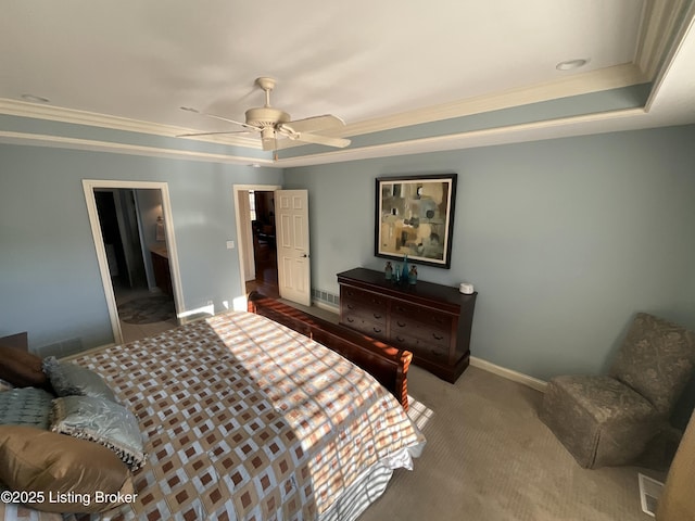 carpeted bedroom with crown molding, a raised ceiling, a ceiling fan, and baseboards