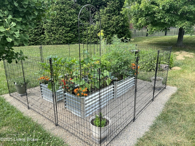 view of gate featuring a garden, fence, and a yard