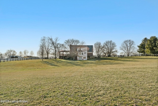 view of yard featuring a rural view and fence