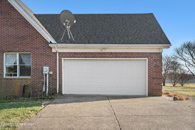 garage featuring concrete driveway