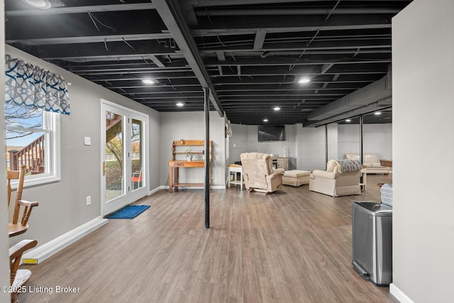 below grade area featuring baseboards and wood finished floors