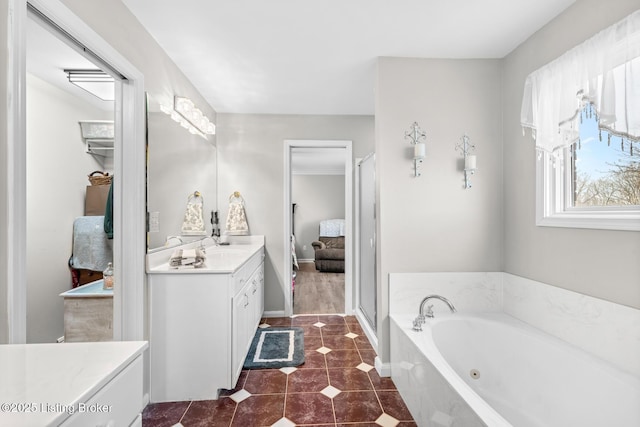 ensuite bathroom featuring vanity, baseboards, a stall shower, tile patterned flooring, and a jetted tub