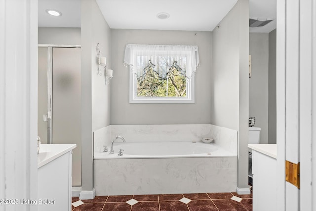 bathroom with tile patterned flooring, a stall shower, vanity, and a bath