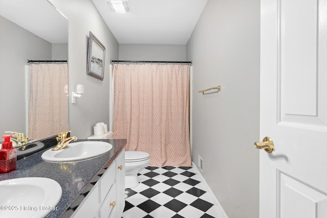 full bath with tile patterned floors, toilet, double vanity, and a sink