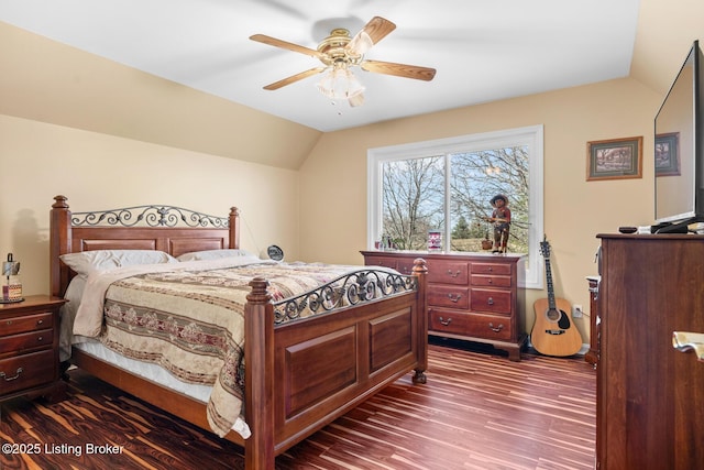 bedroom featuring lofted ceiling, dark wood-type flooring, and a ceiling fan