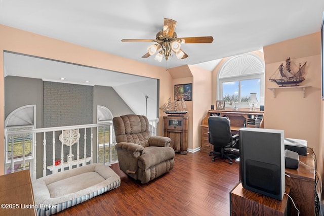 office space with lofted ceiling, wood finished floors, baseboards, and ceiling fan