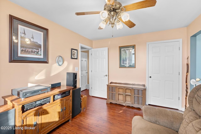 home office featuring a ceiling fan and dark wood-style flooring